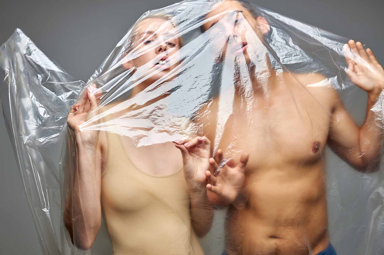 stock photo of models wrapped in plastic wrap