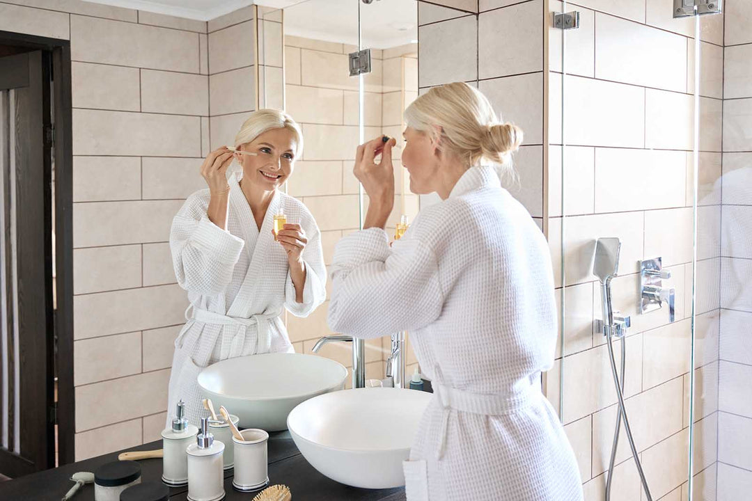 Stock photo of a mature white woman looking in the mirror
