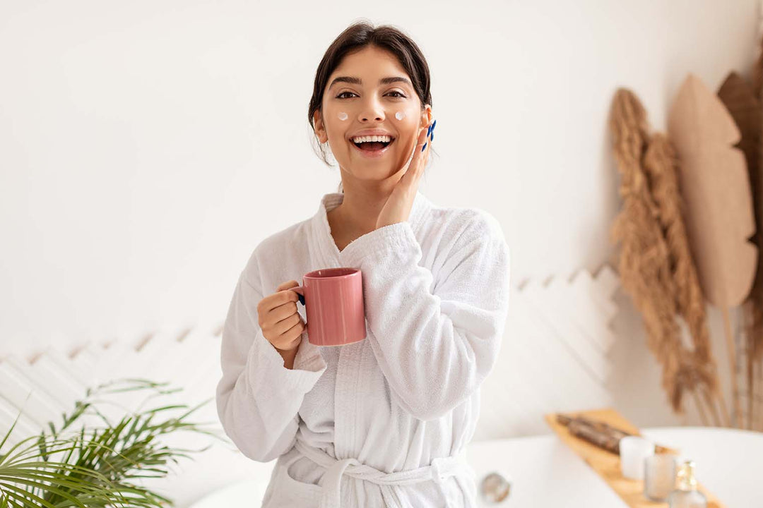 stock photo of woman doing her morning skincare while drinking coffee